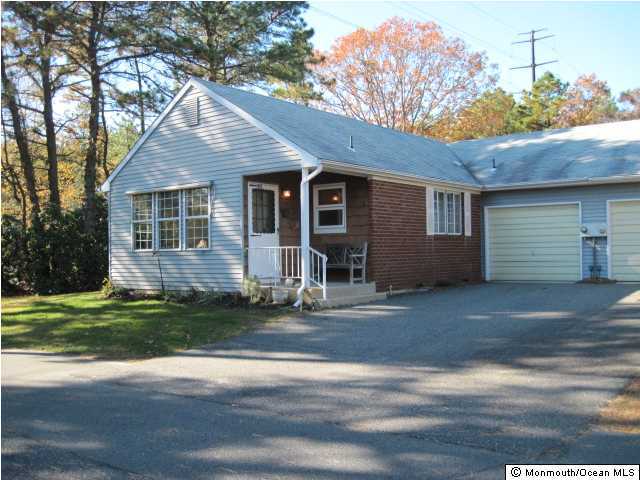 20C Alpine Road, Unit D Whiting, NJ 08759 - Photo 2 of 3 a front view of a house with a garden