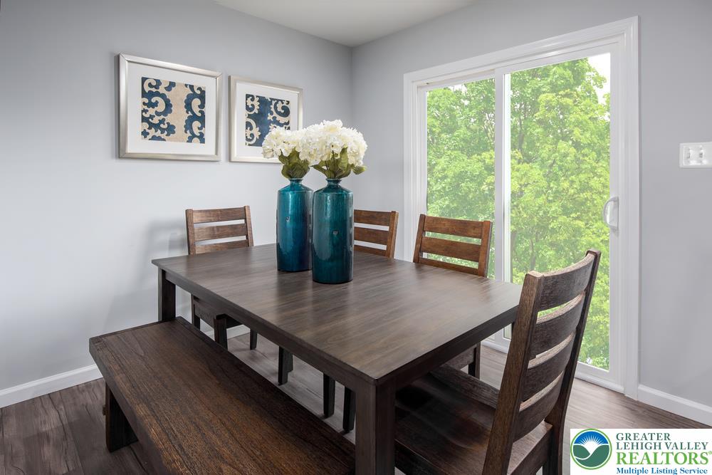66 Shiloh Road, Unit J2 Orwigsburg, PA 17961 - Photo 8 of 14 a view of a dining room with furniture window and wooden floor