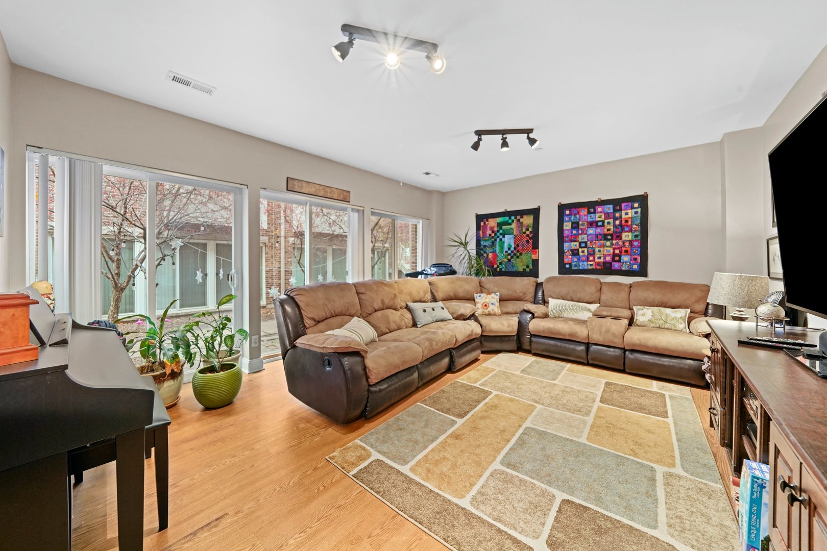 3922 Wehrman Avenue, Unit 3922 Schiller Park, IL 60176 - Photo 11 of 28 a living room with furniture and a flat screen tv