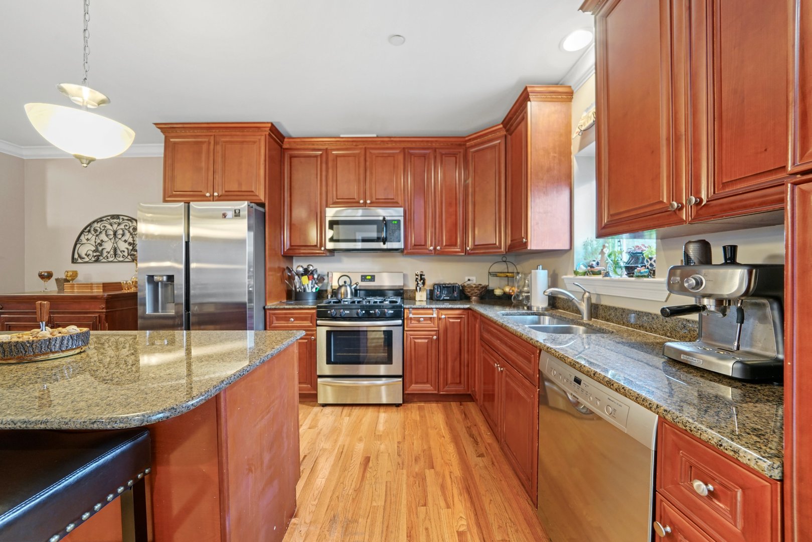 3922 Wehrman Avenue, Unit 3922 Schiller Park, IL 60176 - Photo 9 of 28 a kitchen with stainless steel appliances granite countertop a stove a sink dishwasher and a refrigerator