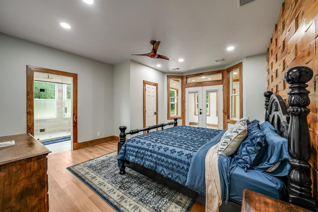 1037 Harrison Road Denison, TX 75021 - Photo 20 of 39 Main Bedroom #1 on first floor featuring wood-finish flooring, recessed lighting, and a wood accent wall