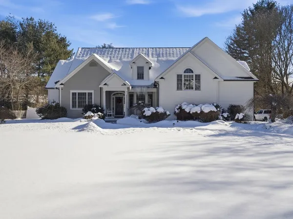a front view of a house with a yard outdoor seating and garage