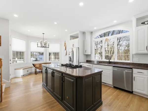 a kitchen with stainless steel appliances granite countertop a stove and cabinets