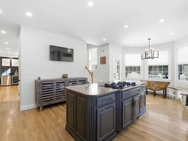 a kitchen with a stove and a wooden floor