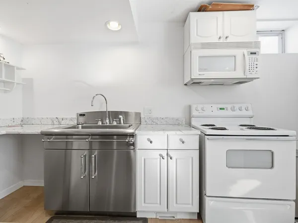 a kitchen with cabinets appliances and a sink