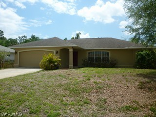 18554 Olive Road Fort Myers, FL 33967 - Photo 1 of 5 a front view of a house with a garden
