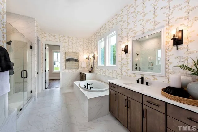 a spacious bathroom with a double vanity sink mirror and shower