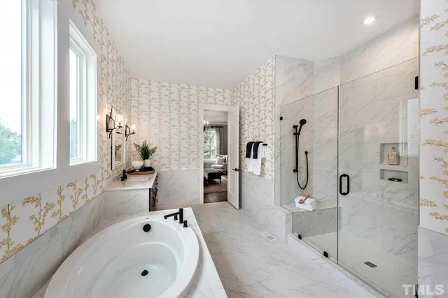 a bathroom with a tub sink and mirror