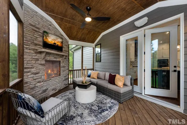 a living room with furniture a fireplace and a table
