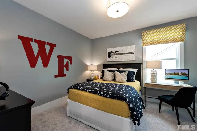 a bedroom with a bed and a chair