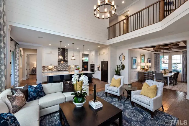 a living room with fireplace furniture and a chandelier