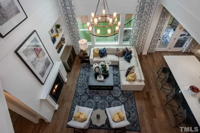 a living room with furniture and a chandelier