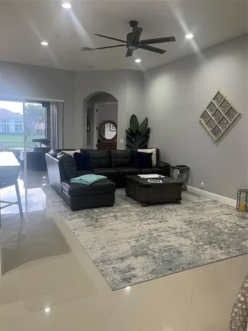 a kitchen with stainless steel appliances kitchen island granite countertop a refrigerator a stove a microwave oven a dining table and chairs