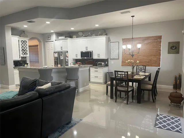 a dining room with furniture and window