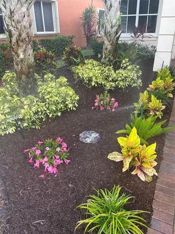 a flower vase with flowers in front of the house