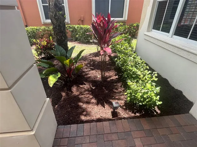 a vase of flowers sitting on a floor