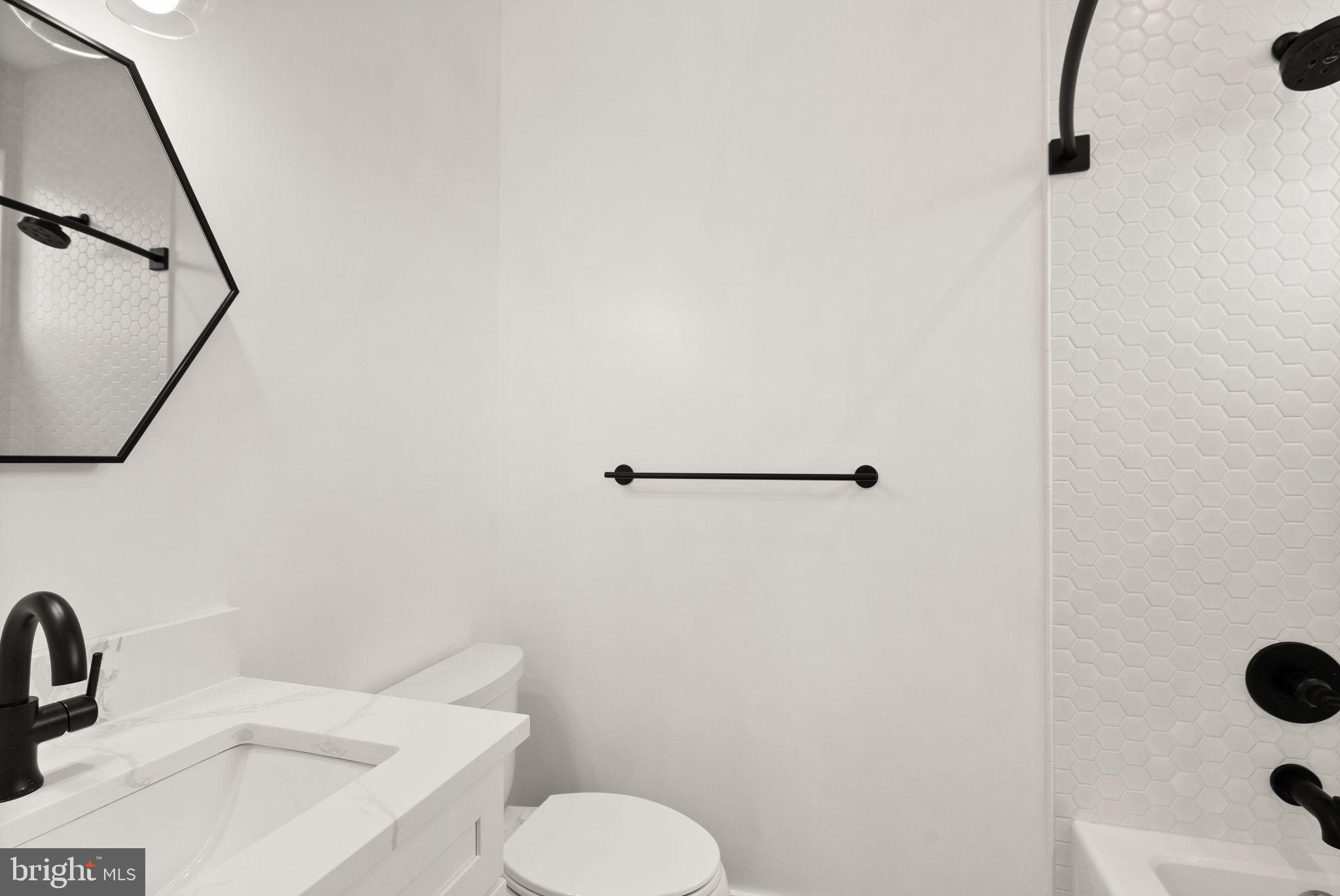 117 17th Street Southeast, Unit 2 Washington, DC 20003 - Photo 22 of 31 a bathroom with a sink toilet and shower