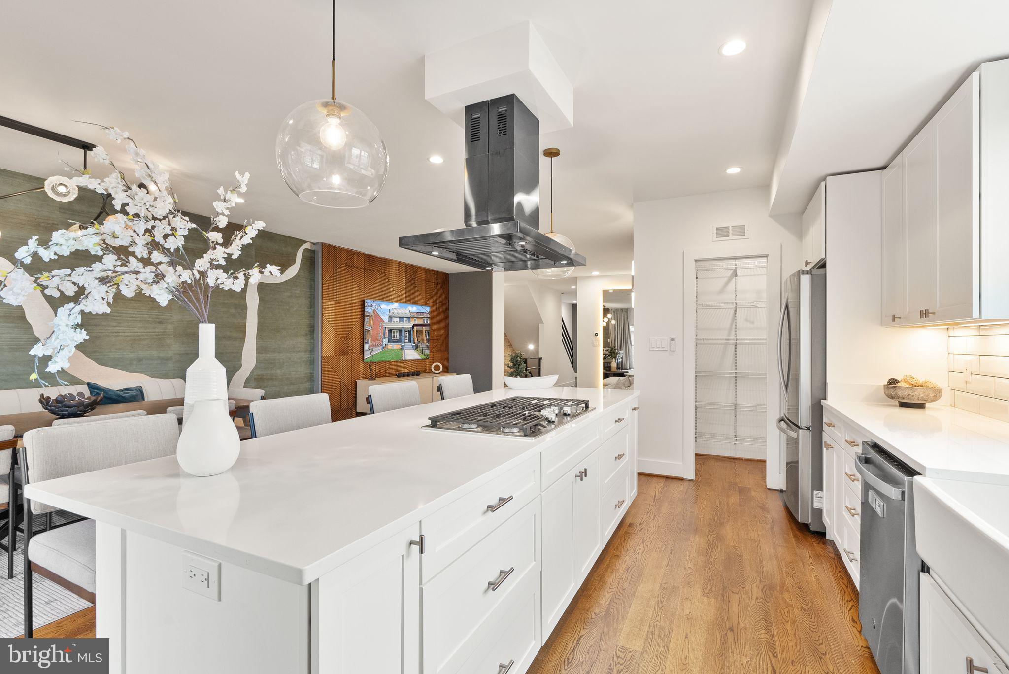 117 17th Street Southeast, Unit 2 Washington, DC 20003 - Photo 9 of 31 a large kitchen with kitchen island a counter space a sink appliances and cabinets