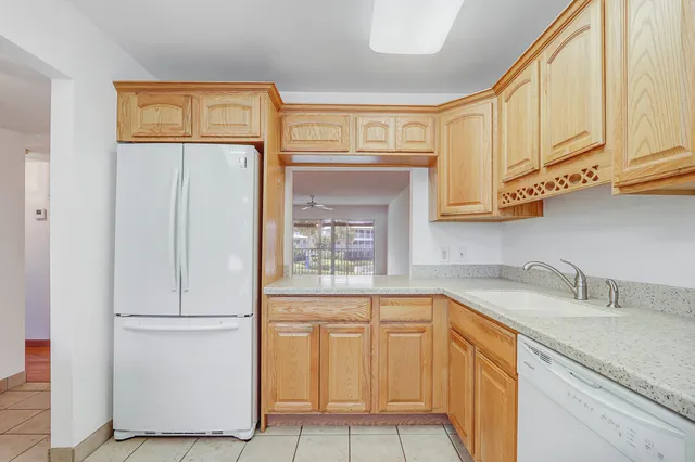 a kitchen with stainless steel appliances granite countertop a refrigerator and cabinets