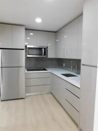 a view of cabinets a sink and dishwasher in a kitchen