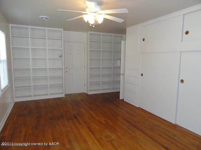 4002 South Jackson Street Amarillo, TX 79110 - Photo 6 of 9 wooden floor in an empty room with a window