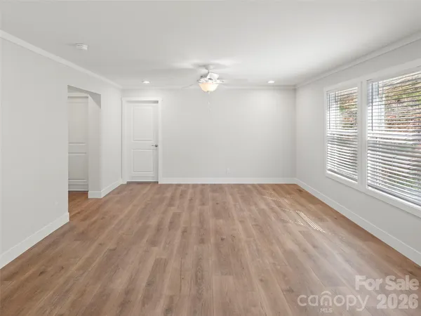 wooden floor in an empty room with a window