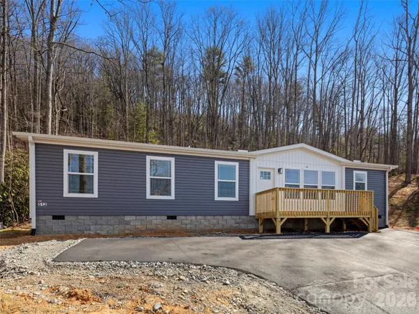 a open kitchen with stainless steel appliances granite countertop a stove top oven a sink dishwasher and a refrigerator with wooden floor