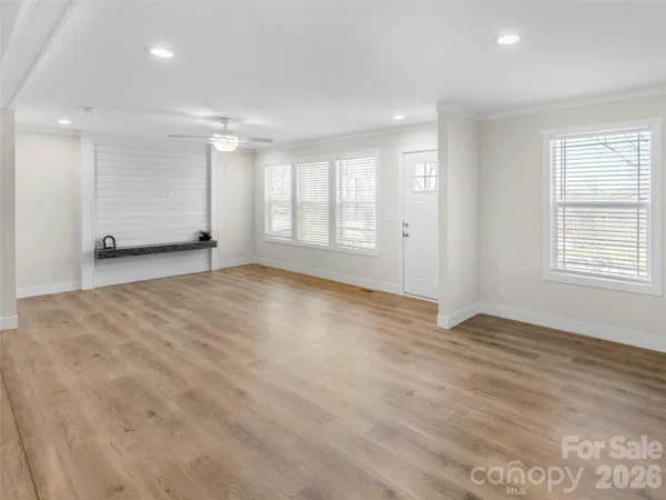 a kitchen with stainless steel appliances kitchen island a table and chairs in it