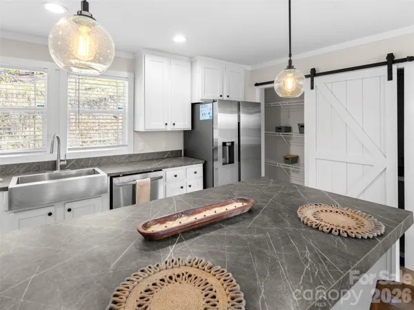 an empty room with windows and ceiling fan