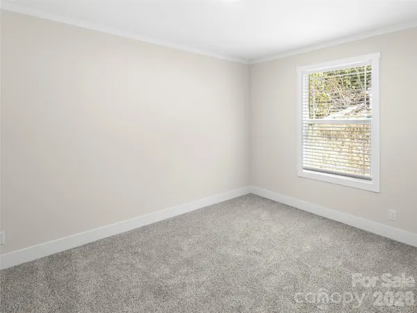 a view of a kitchen sink and wooden floor