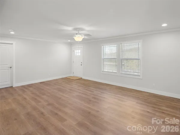 an empty room with windows and closet