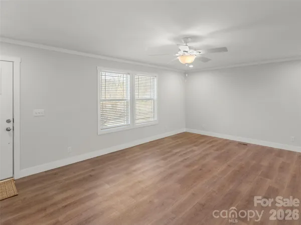 wooden floor in an empty room with a window