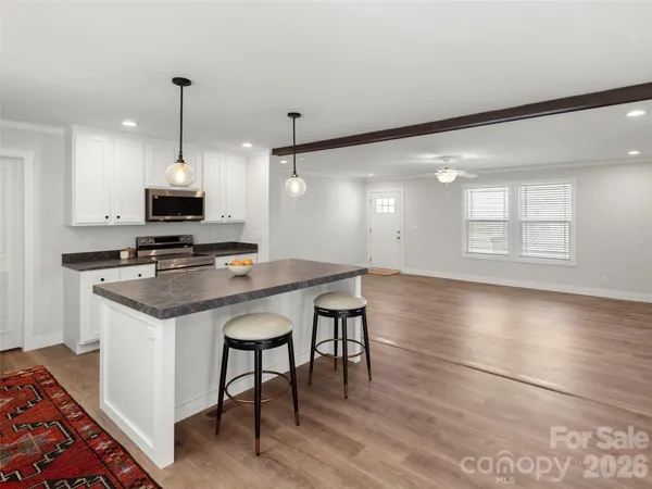 a kitchen with stainless steel appliances granite countertop a stove and a refrigerator