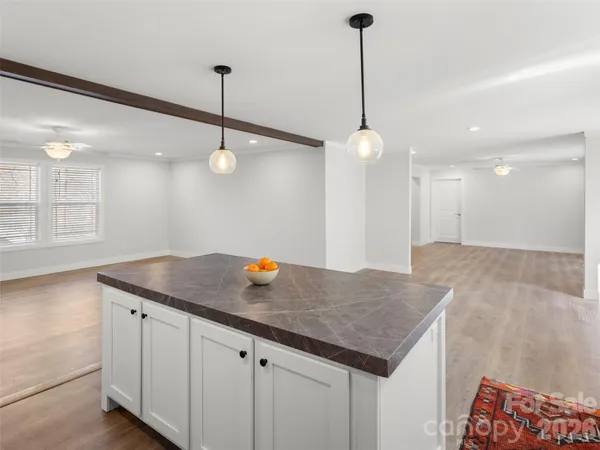 a kitchen with a counter and ceiling fan