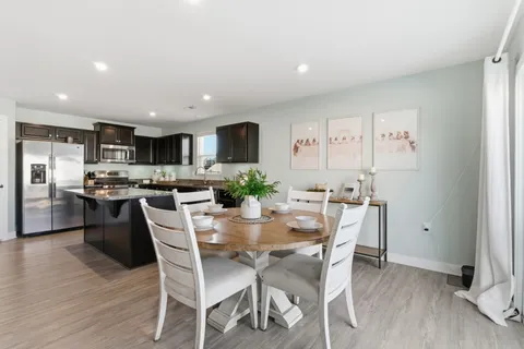 a view of a dining room with furniture and wooden floor