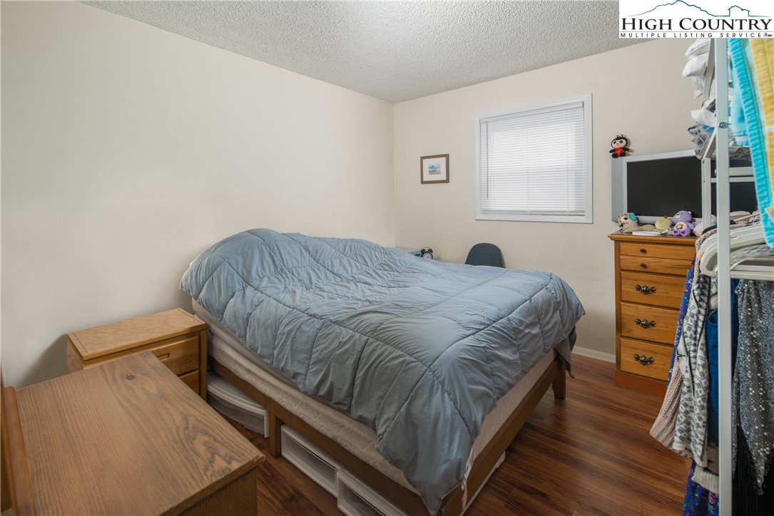 286 Faculty Street, Unit 104 Boone, NC 28607 - Photo 12 of 14 a bedroom with a bed and a flat screen tv