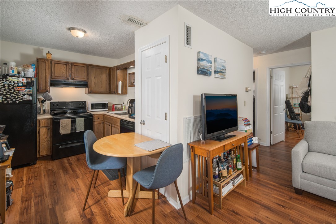 286 Faculty Street, Unit 104 Boone, NC 28607 - Photo 5 of 14 a living room with furniture and a flat screen tv