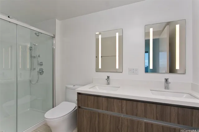 a bathroom with a sink a toilet and shower