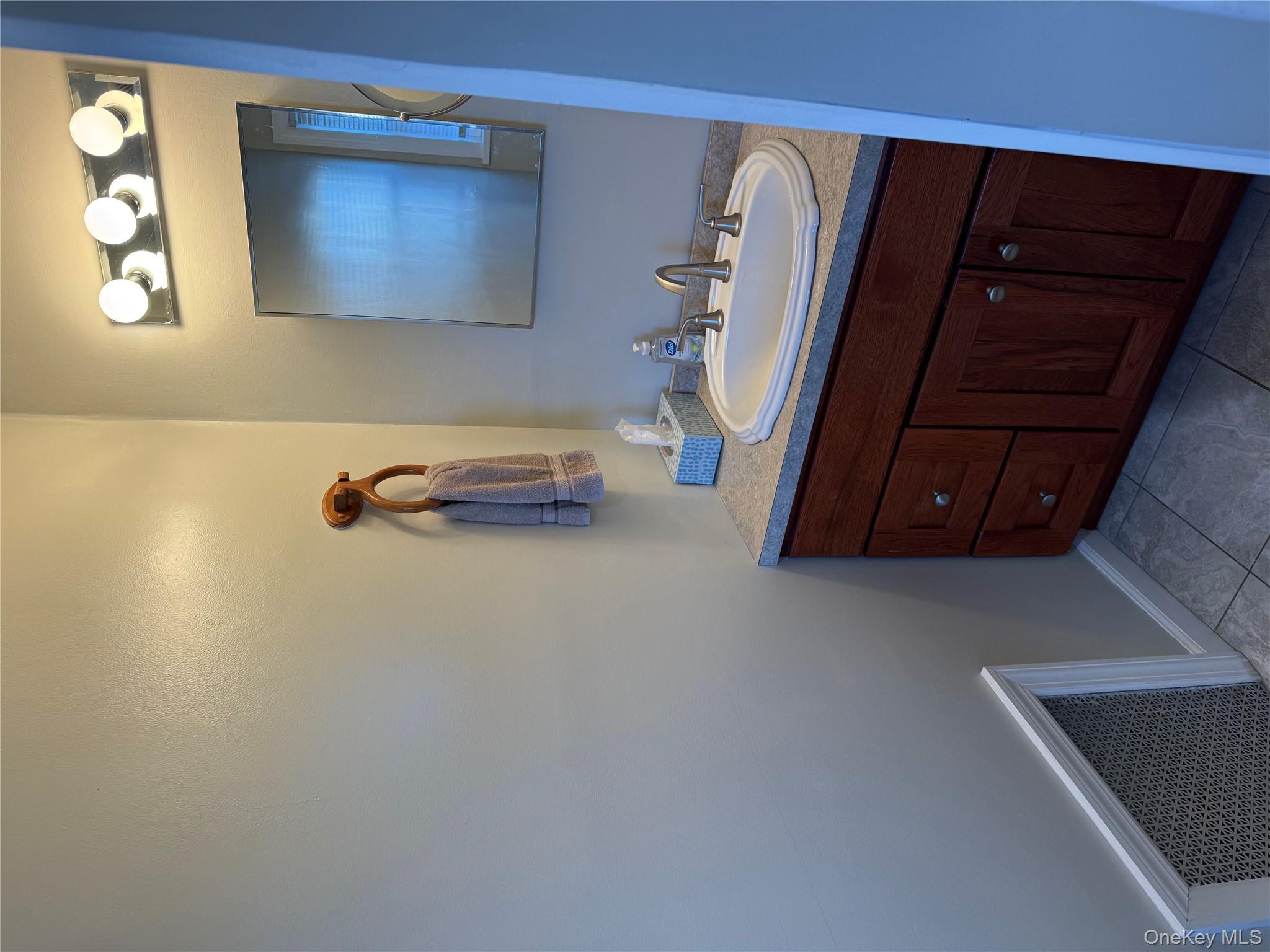 55 Lester Avenue Freeport, NY 11520 - Photo 13 of 38 a bathroom with a sink and a mirror