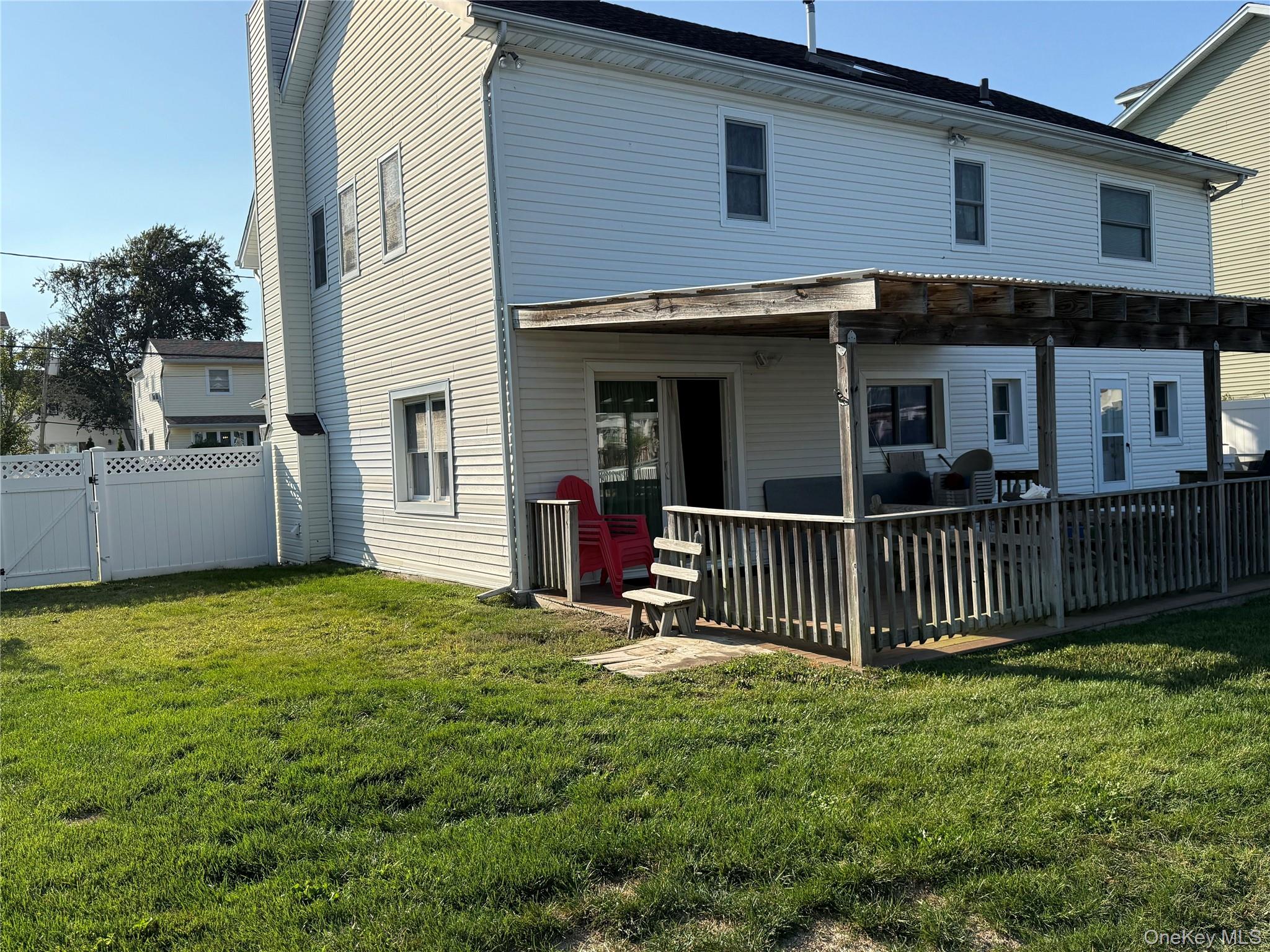 55 Lester Avenue Freeport, NY 11520 - Photo 18 of 38 a view of a house with a yard and deck