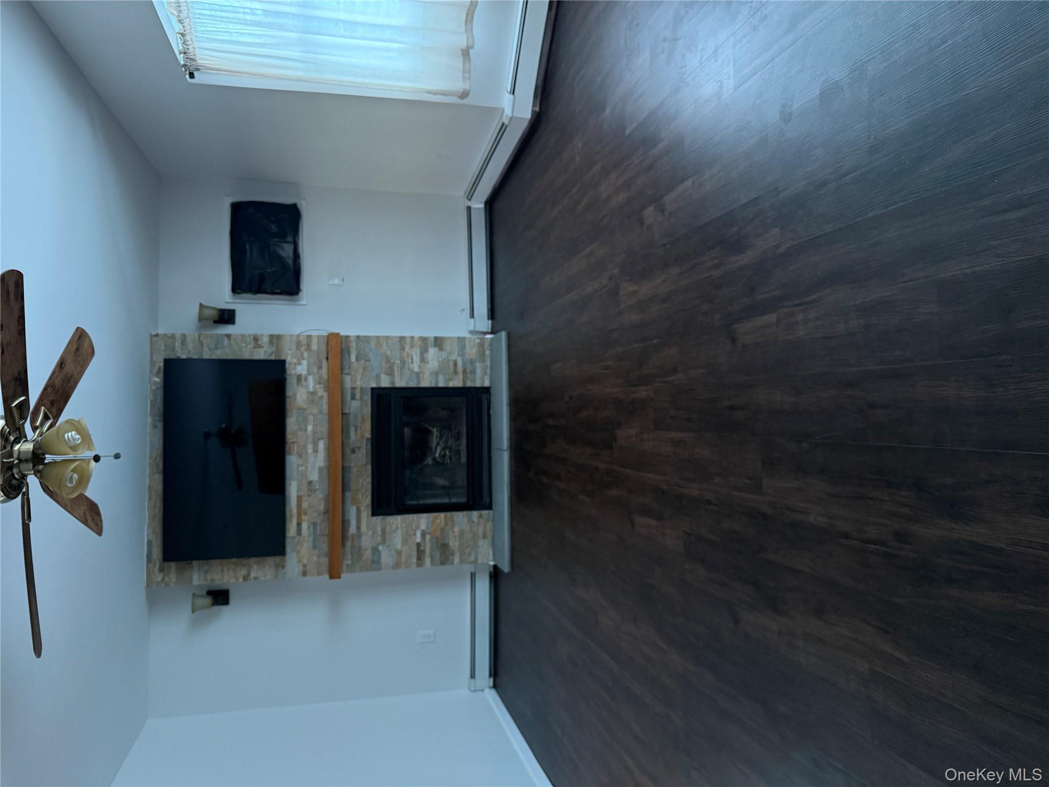 55 Lester Avenue Freeport, NY 11520 - Photo 5 of 38 a living room with a flat screen tv and a fireplace