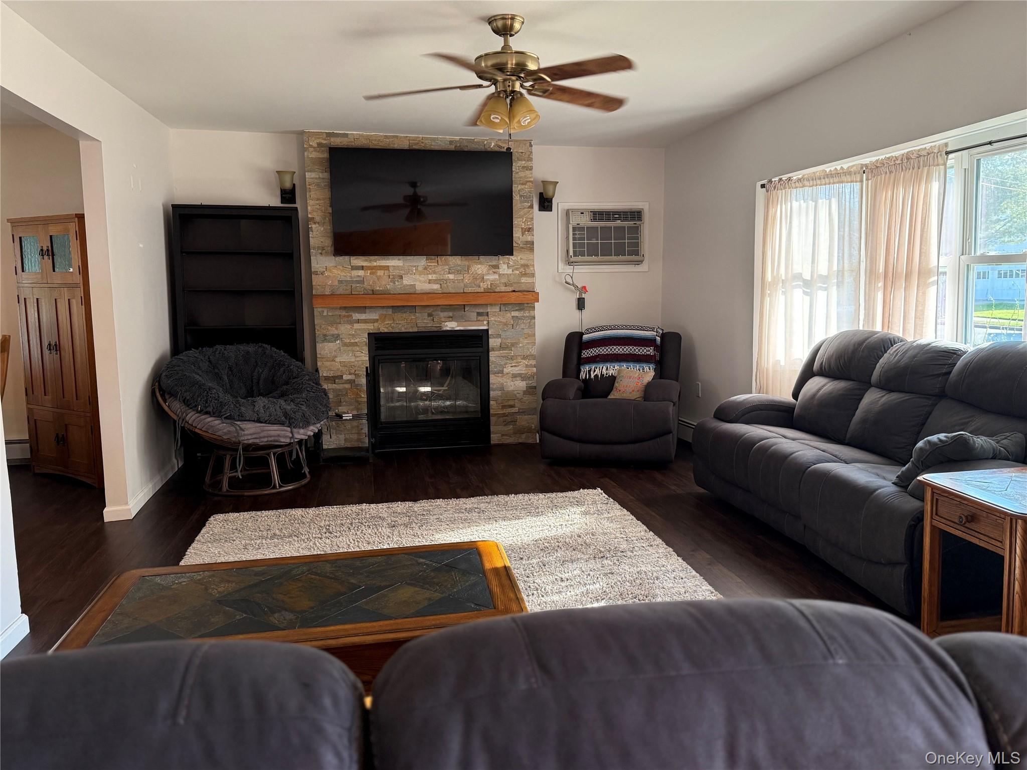 55 Lester Avenue Freeport, NY 11520 - Photo 6 of 38 a living room with furniture a flat screen tv and a fireplace