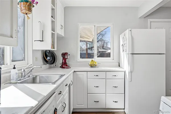 a kitchen with cabinets appliances a sink and a counter top space