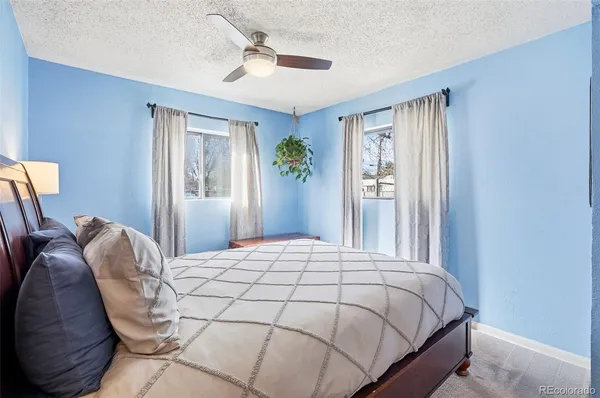 a bedroom with a bed lamp closet and window