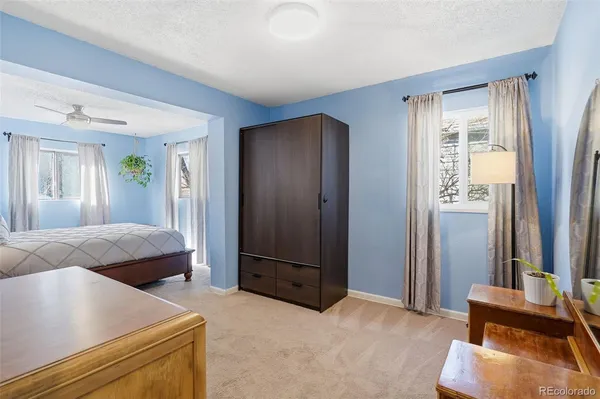 a bedroom with a bed and a mirror