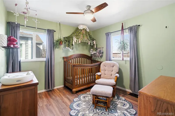 a bedroom with furniture and wooden floor