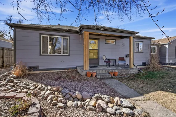 a view of a brick house with many windows next to a yard