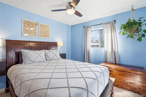 a bedroom with a large bed and a chandelier
