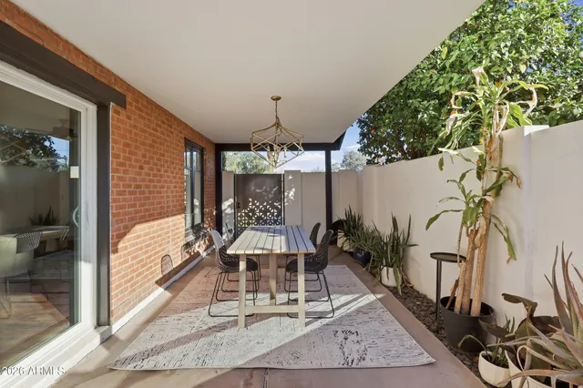 a balcony with furniture and potted plants