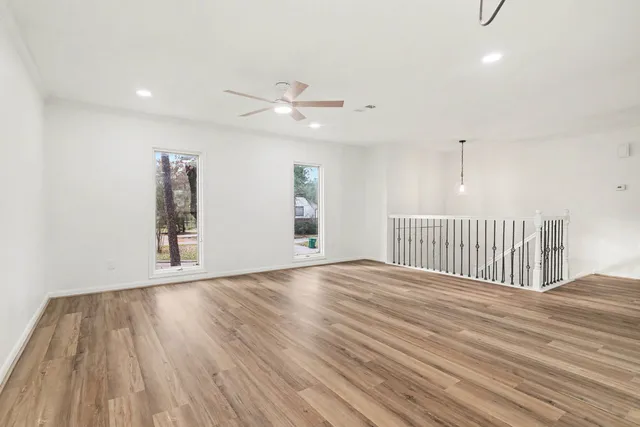 a view of an empty room with wooden floor